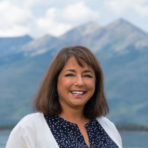 Summit Resort Group Real Estate Broker Dana Cottrell on Lake Dillon with Peak 1 in the background